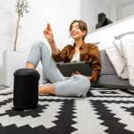 woman-with-a-smart-speaker-and-tablet-at-home