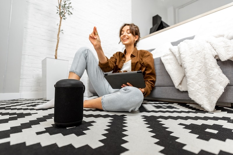 woman-with-a-smart-speaker-and-tablet-at-home
